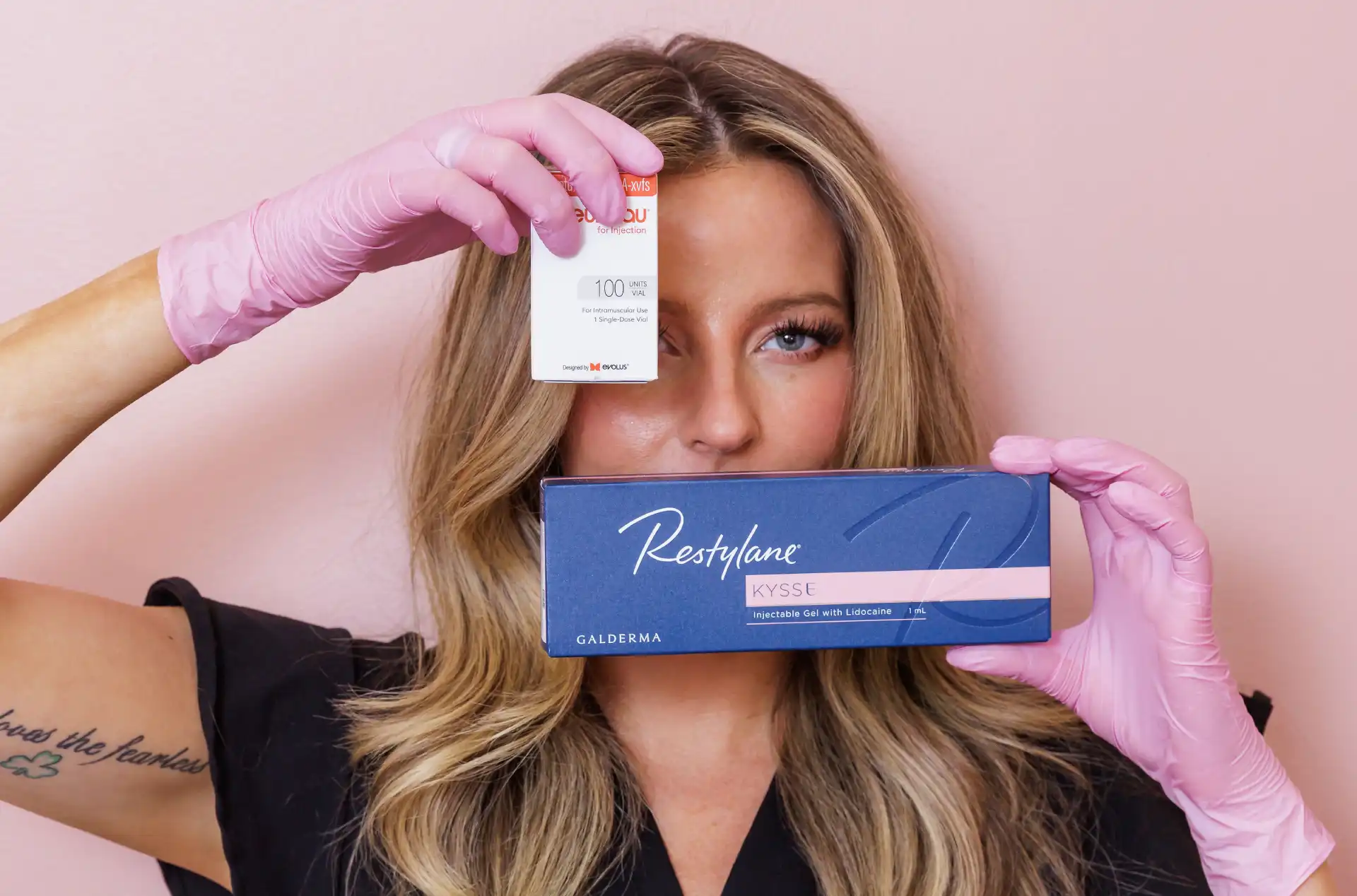 Woman holding Restylane filler box and smiling at One Eleven RX Auburn, MA