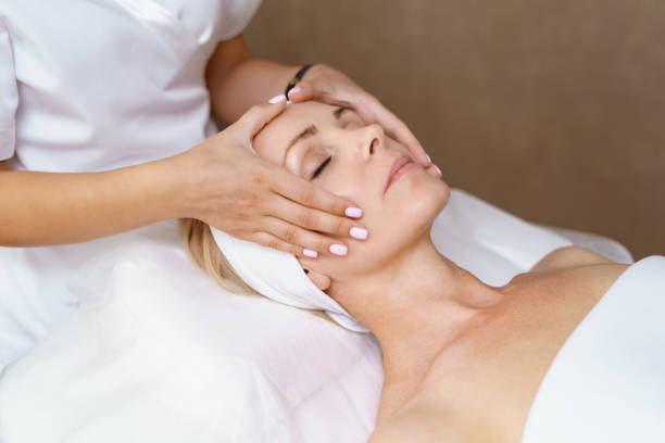 Aesthetic specialist assessing skin condition with focused technique and professional attention