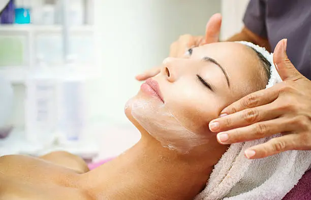 Client receiving facial aesthetic consultation before a special event in Northfield treatment room