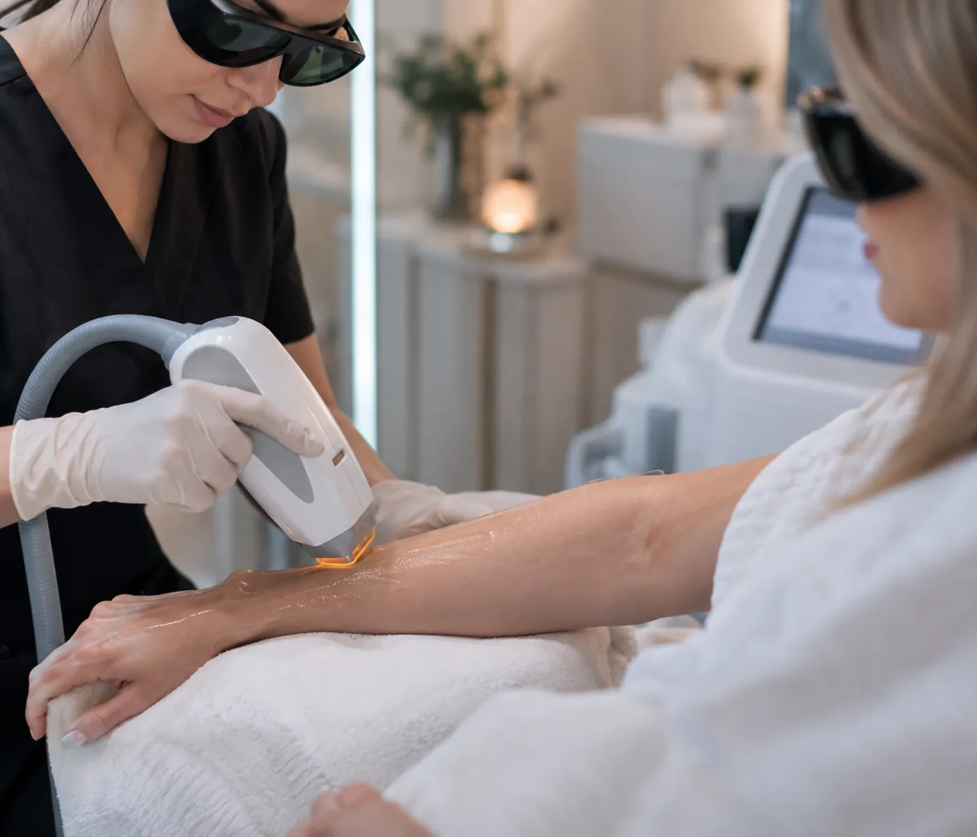 Laser Skin Removal in Leominster - MA specialist adjusting equipment before a scheduled treatment session